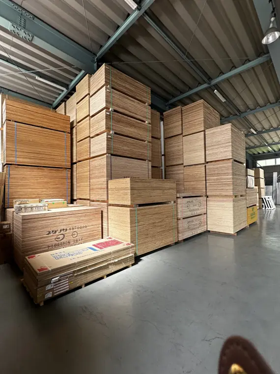 Crated Japanese gypsum board and ceiling panels staged for container loading